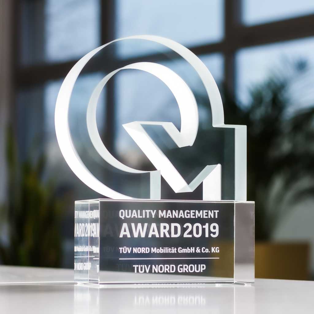 Water-jet cut glass with frosted edges. Glass cube base with inner 2D engraving.